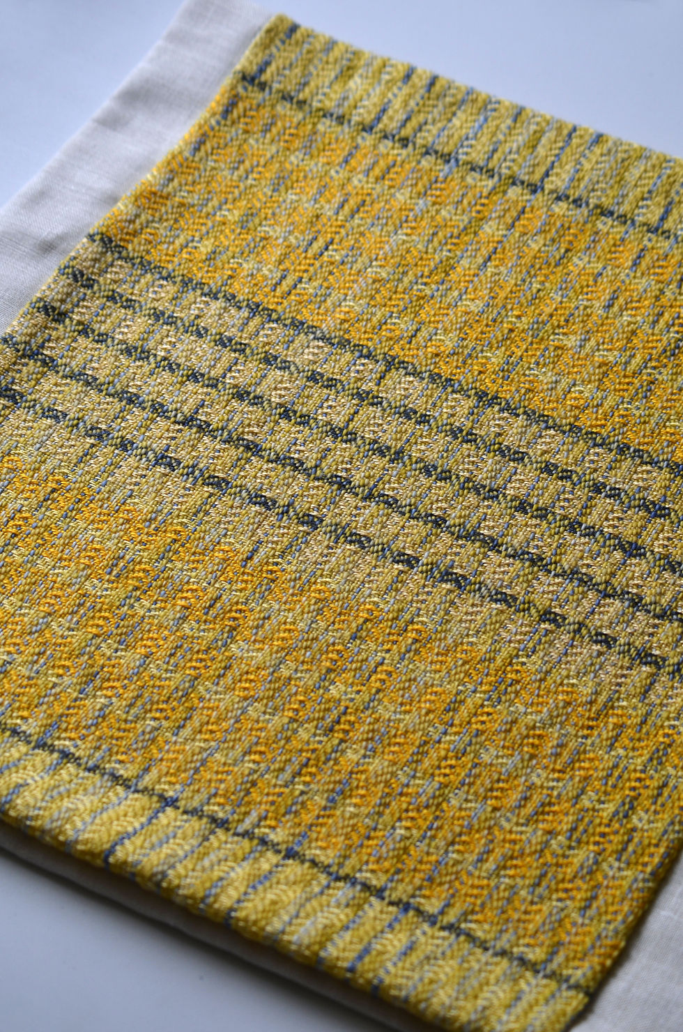 blue and yellow woven pillow detail
