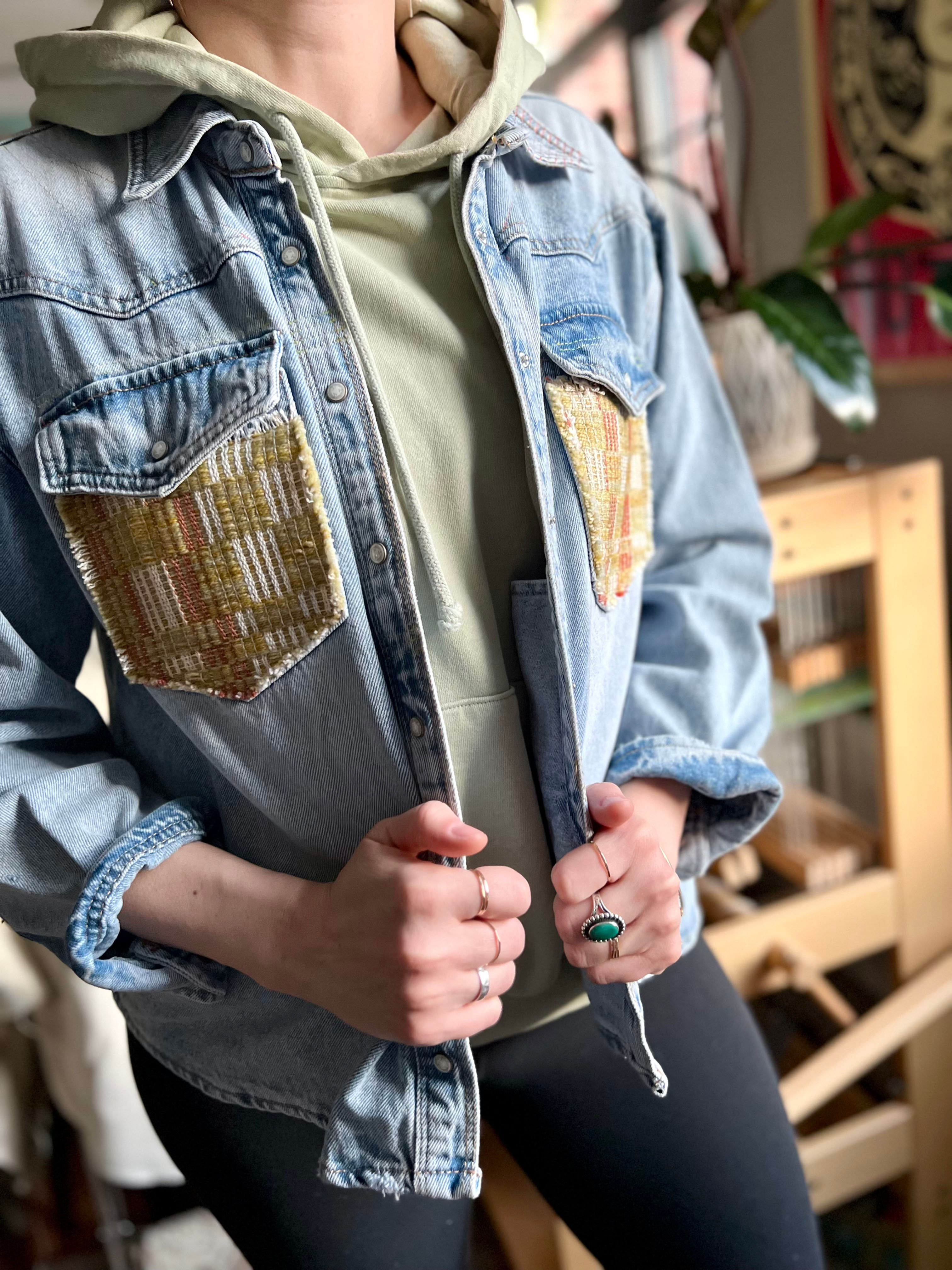 detail view of denim jacket on model