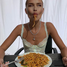 a girl eating pasta