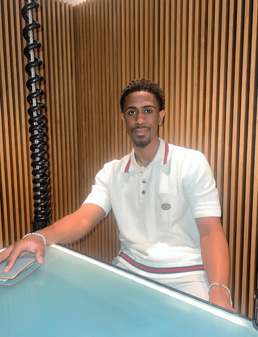 Brock Washington of Michigan seated at a table.