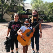 Mish and Kirst from Mish's Music School with a student after their guitar lesson