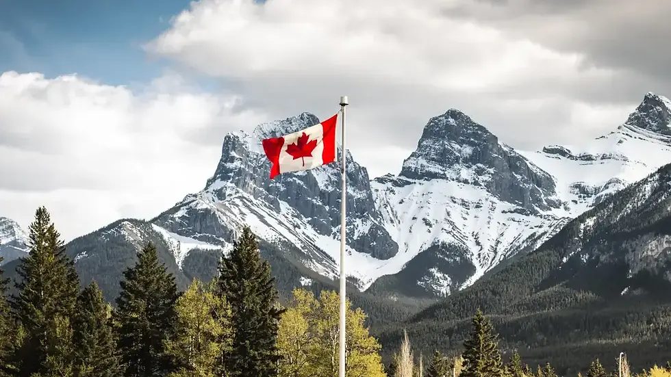 Canada flag with mountains in the background