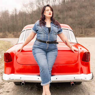woman propping seductively on an antique red car in Northern Kentucky