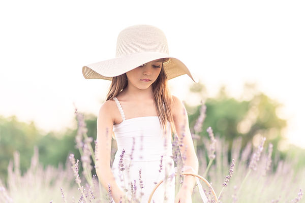 girl in white dress and floppy hat in lavender field