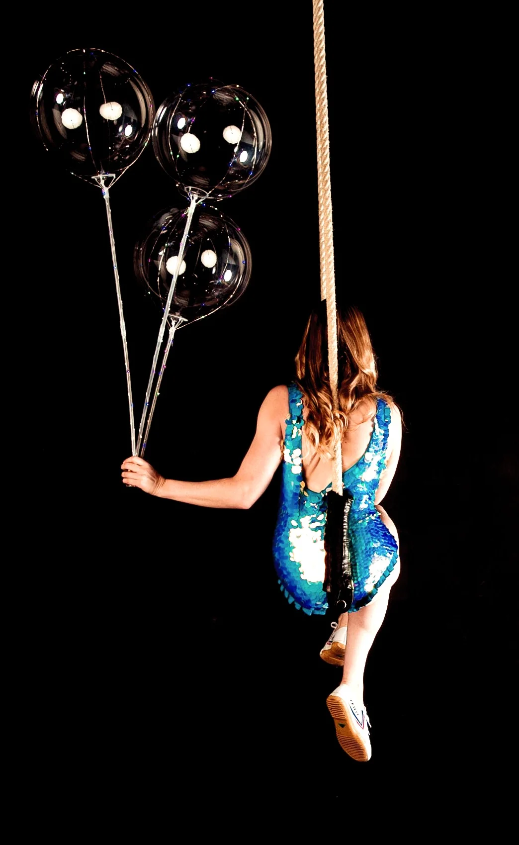 Blue Rosa Bloom costume on trapeze with three led balloons