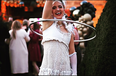 Hula Hooping in a white dress with a silver hoop at Prestonfield House