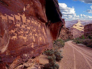 Petroglyphs in Nine-Mile Canyon next to red dirt road