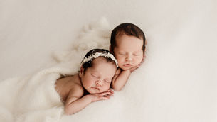 Newborn twins sleeping neutral cosy blanket