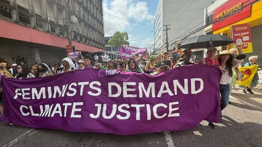 The Women and Gender Constituency (WGC) march behind their bold “Feminists Demand Climate Justice” banner during the Global Day of Action on November 15 during COP30 in Belém, Brazil. The WECAN team was honored to march with this vibrant contingent. Photo Credit: Katherine Quaid / WECAN