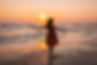 beautiful-shot-model-wearing-brown-sundress-enjoying-sunset-beach.jpg