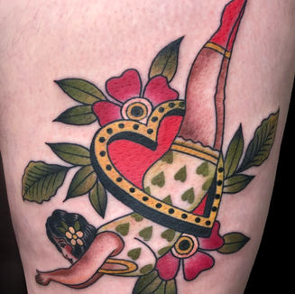Lady diving through a heart tattoo on a leg