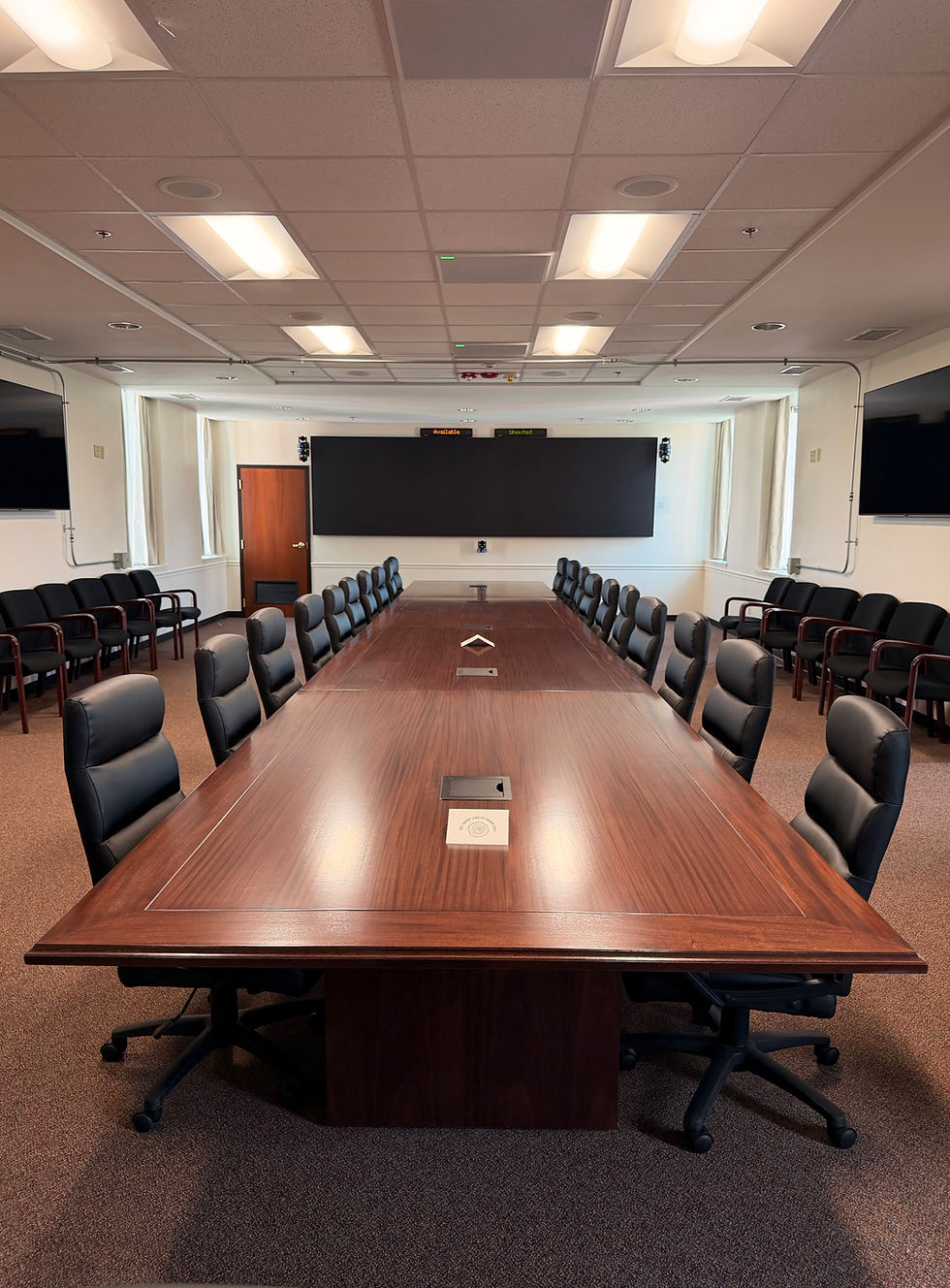 Long mahogany conference table in a corporate boardroom