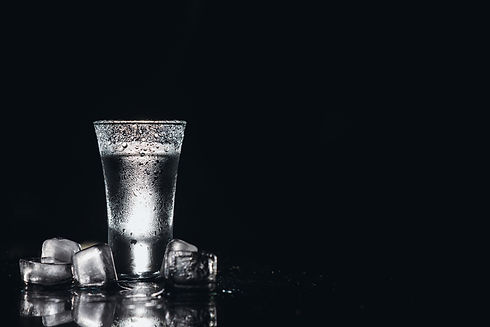 Vodka Shots, glasses with vodka with ice Dark background Copy space Selective focus.jpg