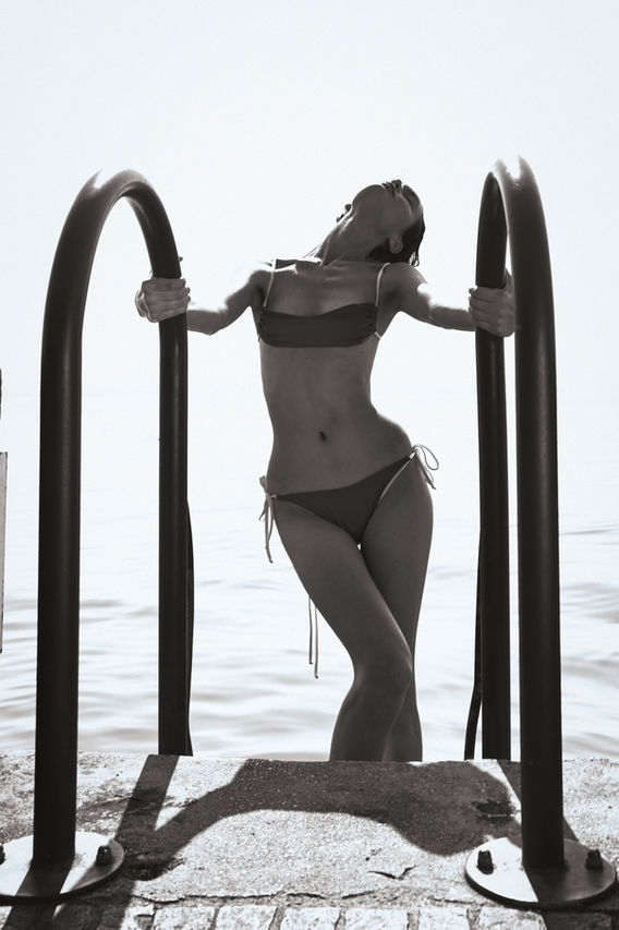 beautiful girl in swimwear getting out of the lake