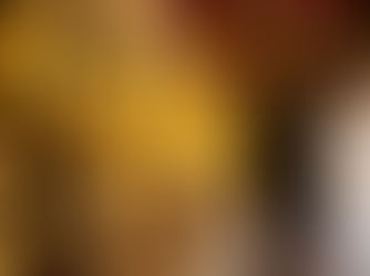 Symmetrical row of golden Buddha statues in the peaceful cloister of Wat Suthat temple in Bangkok Old Town