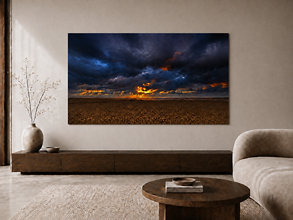Blue landscape fine art photograph displayed above a sofa in a contemporary living room