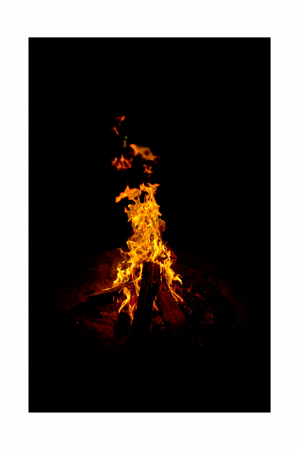 Fire fine art photograph of orange flames rising against a black background