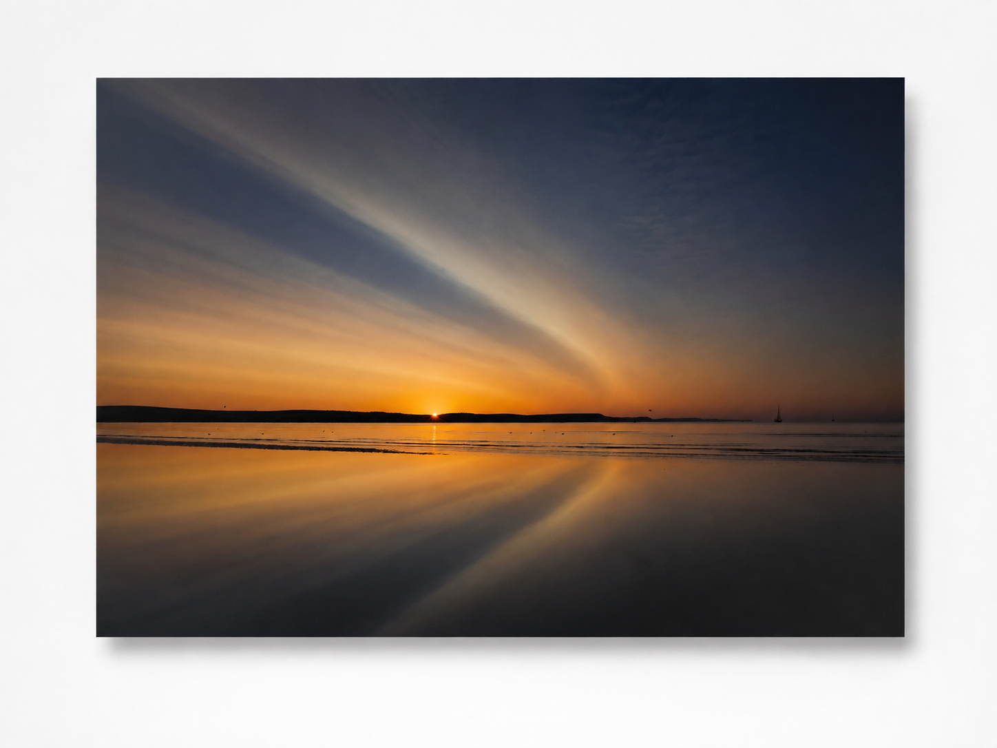 Colourful sunrise reflected across Weymouth Beach