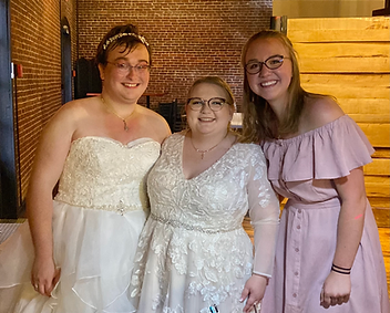 Three women smiling and holding each other