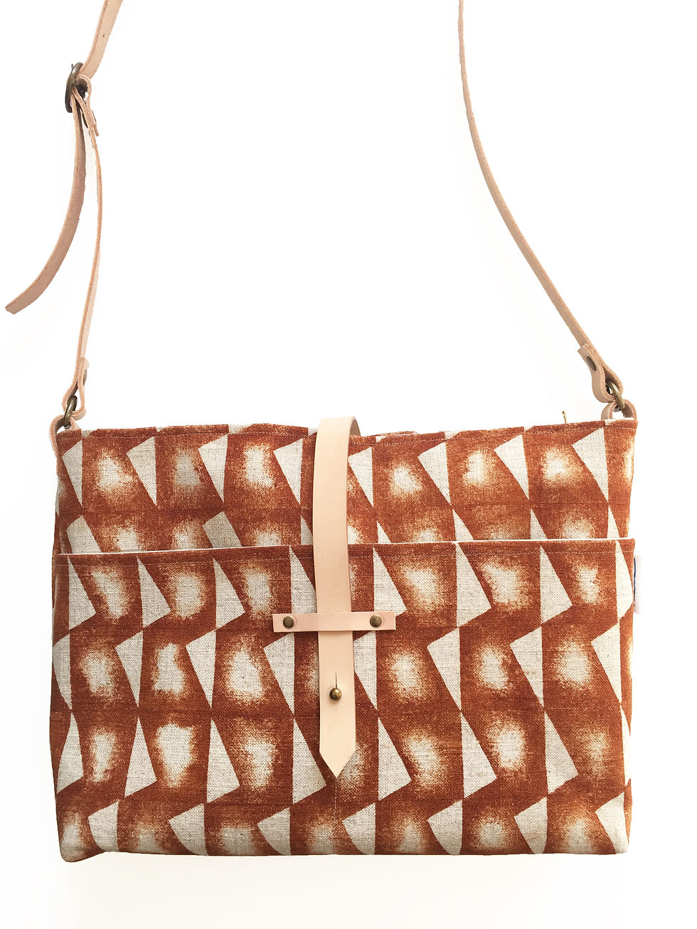 A stencil printed linen cross body bag with leather straps