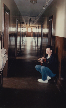Upper corridor, Prince Building. Sterling McAskill making music.