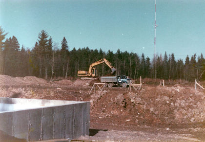 Foreground – Field training building wall.