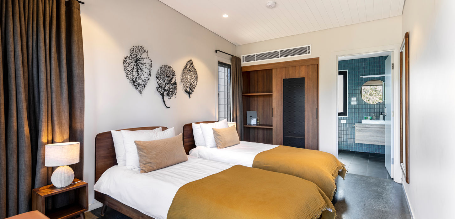 Guest suite with chairs, bed, and deck access at KVBR.