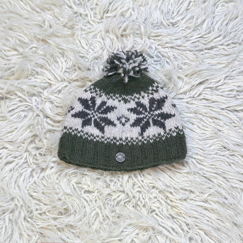 Snowflake bobble hat in green. By Black Yak