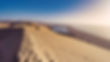 Sandy coastal dunes and ocean view with blue sky. Sandwich Harbour Trips