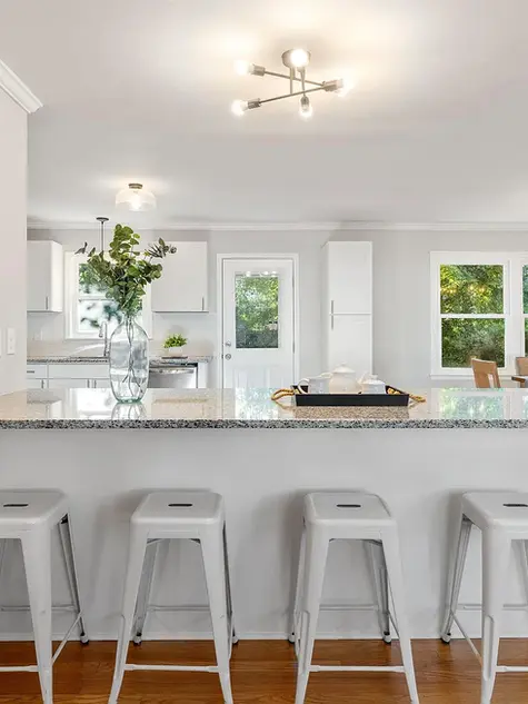 Renovated kitchen with large island, seating, and updated finishes