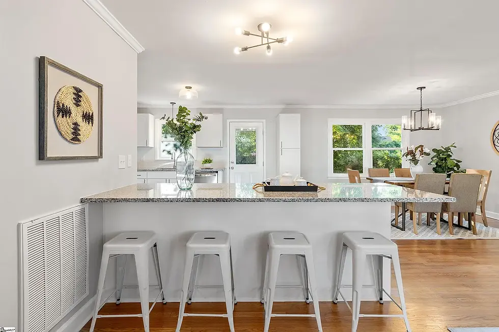 Open concept kitchen and dining area with large island, seating, and hardwood flooring