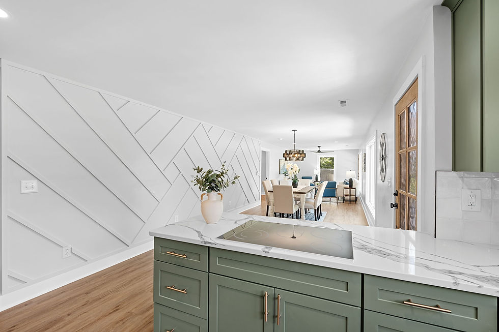 Renovated kitchen with green cabinetry, quartz countertops, and open concept dining area