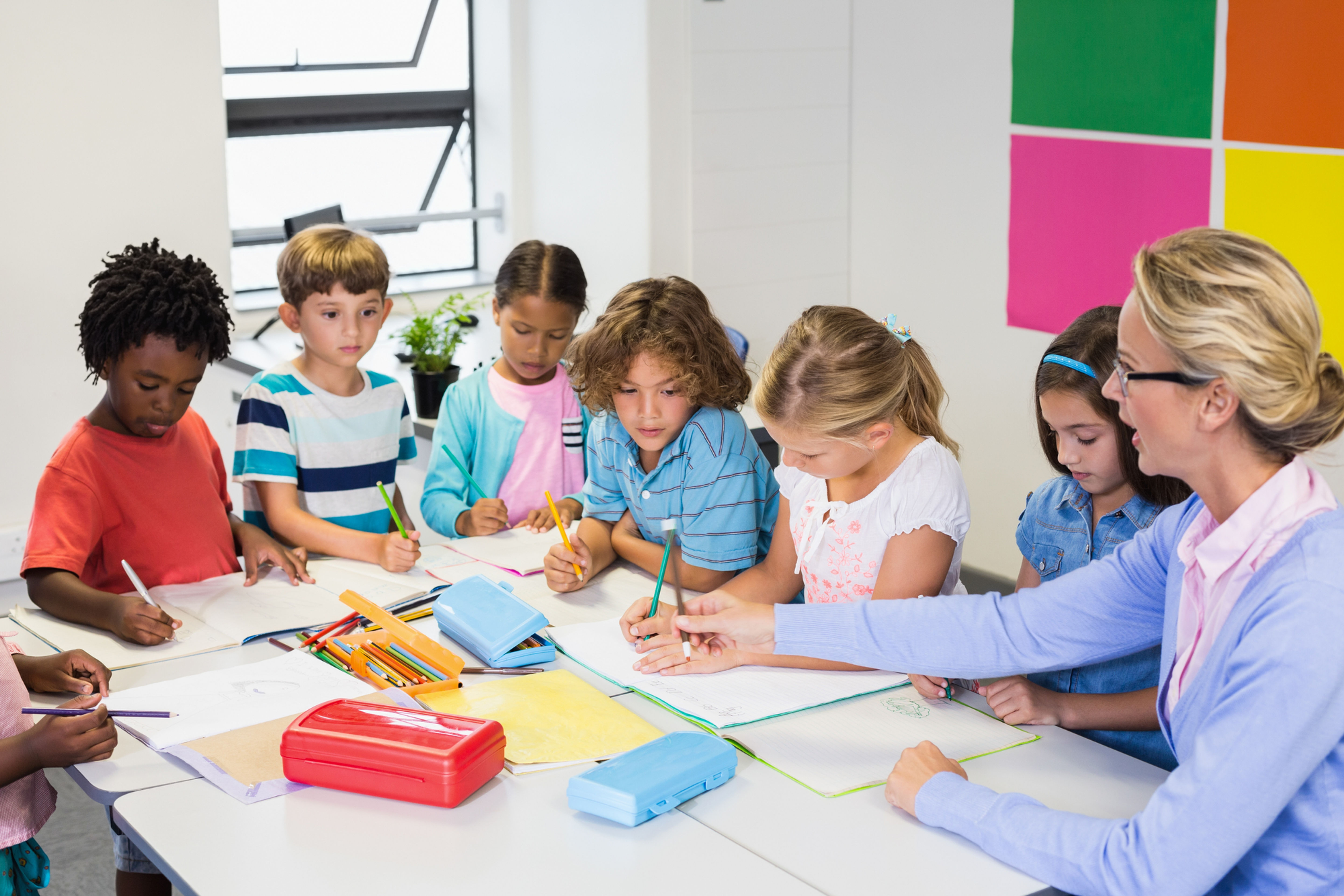 Teacher working with students in a classroom. 