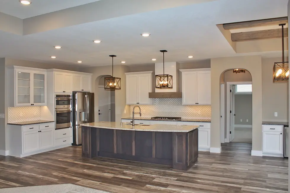 Modern kitchen with island, stainless steel appliances, and white cabinets for design inspiration.