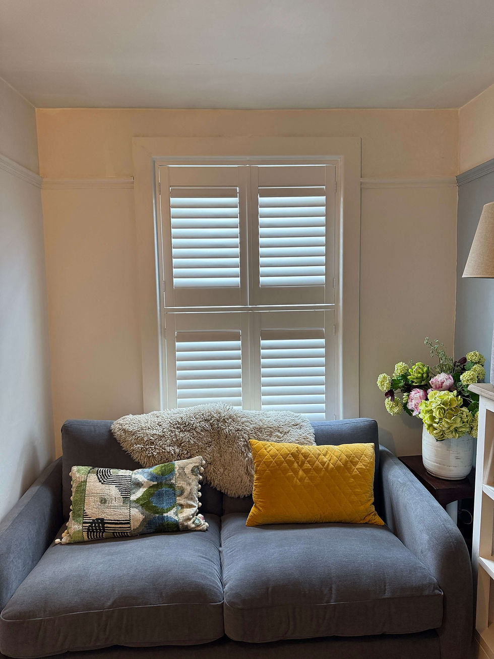 Tier-on-tier hardwood shutters in a Suffolk sash window showing three configurations — both open, upper open lower closed, and both closed