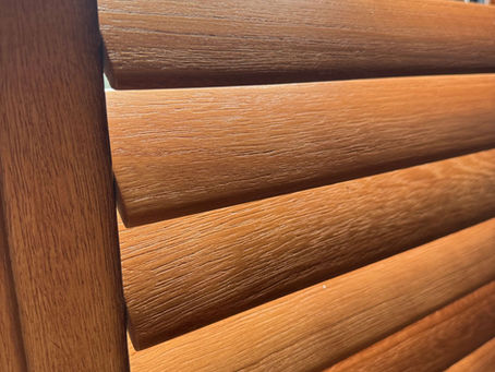 White and natural wood hardwood shutters by Miavalentina Interiors showing the two main finish options for Suffolk homes
