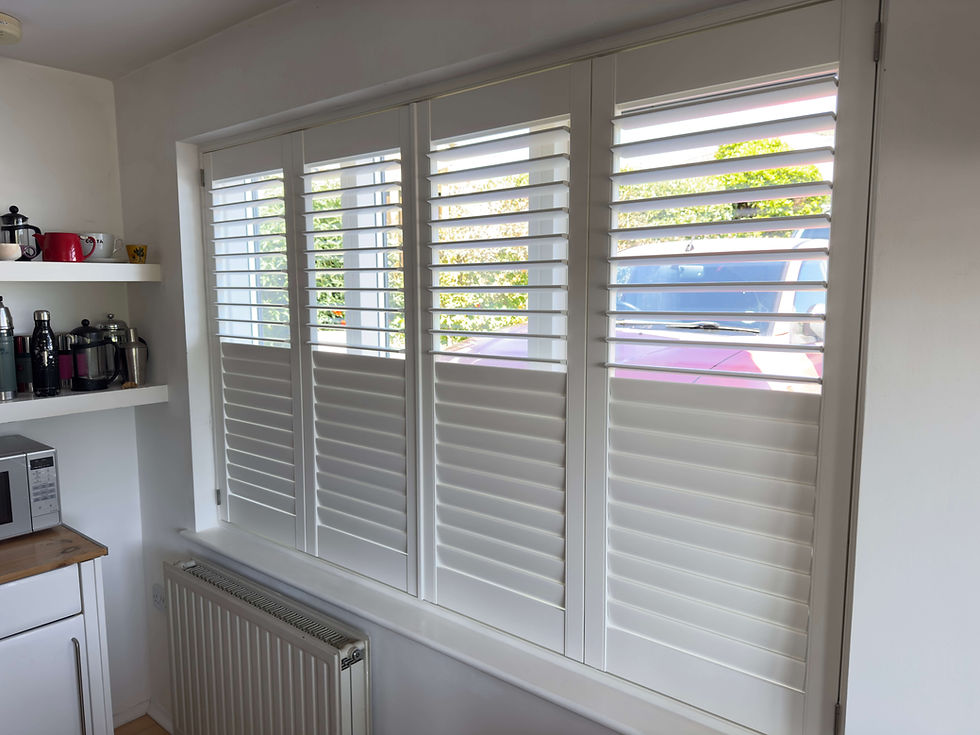Hardwood shutters by Miavalentina Interiors in a Suffolk home showing privacy with natural light through tilted louvres