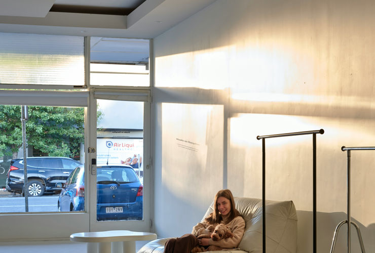 Woman sitting comfortably in a modern armchair in a therapy office, eyes closed, looking relaxed