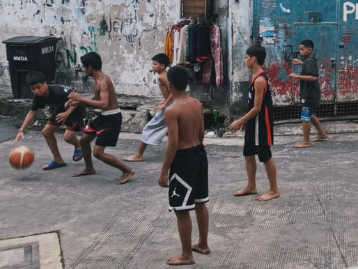 Youth gather on an open court to play basketball in Manila, photo by Kevin Tristan Espiritu