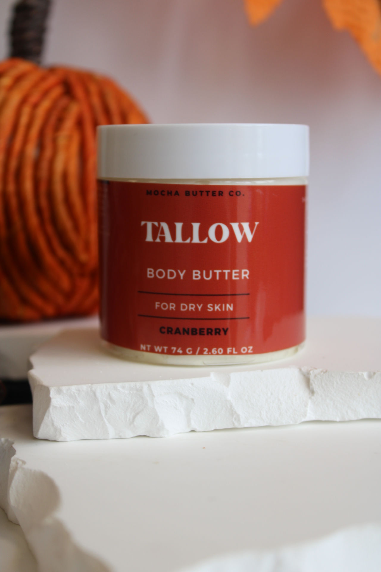 Tallow Body Butter jar with text, for dry skin, Mocha Butter Co. pumpkin background.
