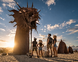 Monumental dragon sculpture in desert light.png