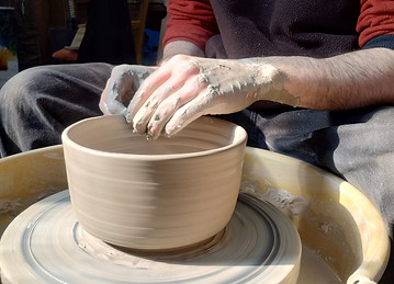 Stoneware bowl being thrown on the wheel