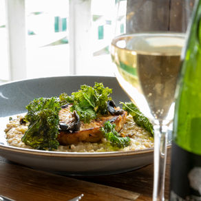 plate of food with glass of wine and bottle