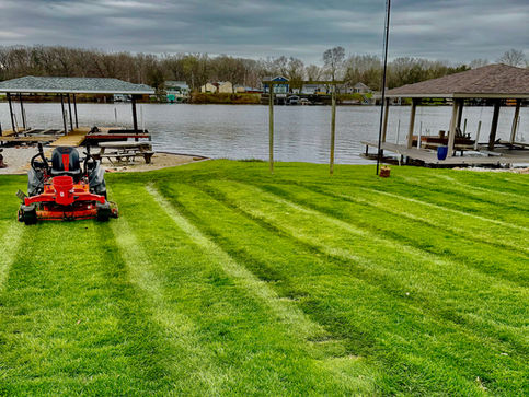 Commercial zero-turn lawn mower cutting grass for a weekly lawn care service in Brookston, IN.