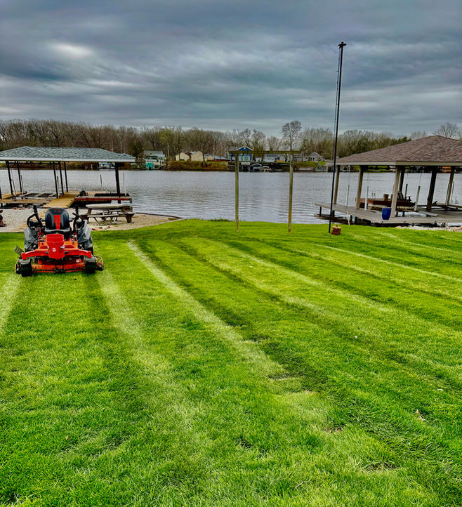 Commercial zero-turn lawn mower cutting grass for a weekly lawn care service in Brookston, IN.