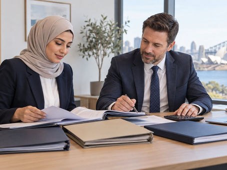 An investor and a financial professional reviewing several separate unmarked asset folders with a calculator in a calm office in Australia