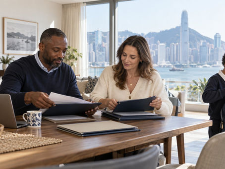 An international family arranging separate unmarked document folders at a sunny home dining table while a school age child packs a school bag nearby in Hong Kong