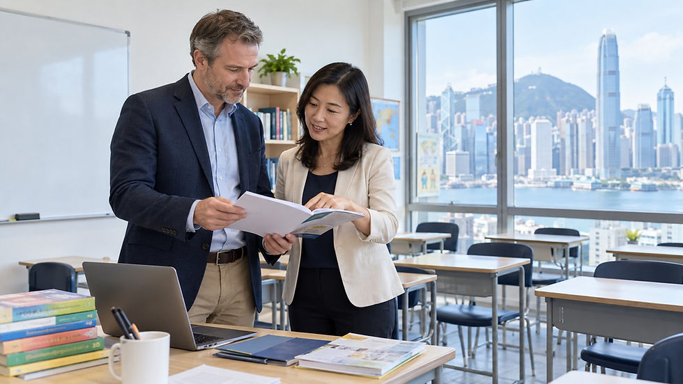 An international teacher or trainer reviewing teaching materials with an employer in a bright empty classroom in Hong Kong