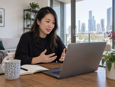 An adult Australian Chinese professional having a career planning video meeting from a Melbourne apartment