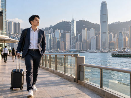 Newly arrived technical professional carrying luggage through a Hong Kong harbour district